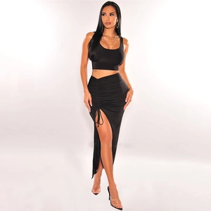 Black two-piece set featuring a ruched crop top and high-slit maxi skirt for a slim fit