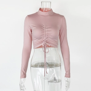 Detail of light pink long sleeve crop top showing adjustable front drawstring ruching