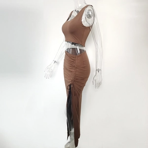 Side view of brown crop top and maxi skirt with side drawstring and high slit detail