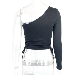 Detail of black one-shoulder cropped top with adjustable side drawstrings and ruching