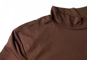 Detail shot of the mock neck and seamless shoulder stitch on a brown slim-fit dress