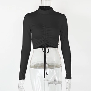 Close-up of ruched front with adjustable drawstring on black long sleeve crop top