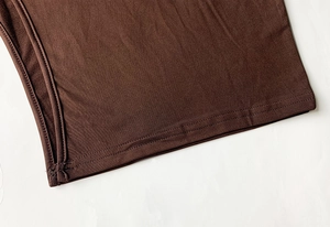 Macro detail of dark brown knit fabric showing professional double-needle stitching
