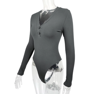 Detail of ribbed knit bodysuit featuring deep V-neck and decorative front buttons