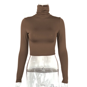 Detail of slim-fit brown turtleneck crop top showing high-quality elastic fabric texture