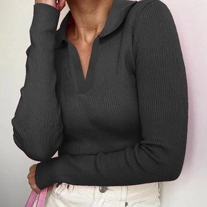 Detail of dark grey ribbed knit long sleeve polo shirt showing deep V-neck and collar