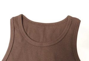 Detail shot of brown ribbed knit dress neckline featuring clean double-needle stitching