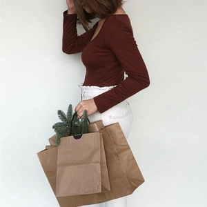 Close-up of rust red slim fit crop top featuring a square neck and soft ribbed fabric