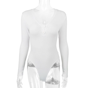 Close-up of white ribbed knit bodysuit featuring a deep V-neck and decorative button detail