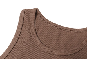 Macro detail of brown ribbed knit dress showing round neckline and premium stitching
