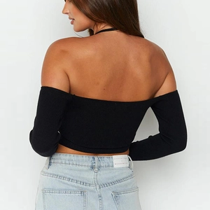 Close-up back view of a slim-fit black off-shoulder ribbed long sleeve top for women