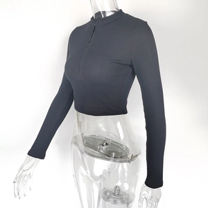 Detail of black ribbed long sleeve crop top with half-zip stand collar on mannequin