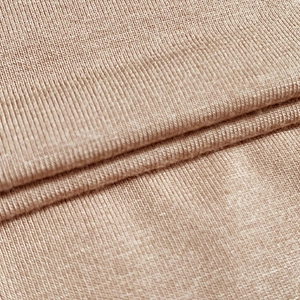 Close-up of beige ribbed knit fabric texture on a slim fit cropped U-neck T-shirt