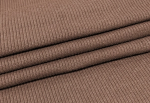 Detailed macro view of the brown ribbed knit fabric texture and soft elastic material