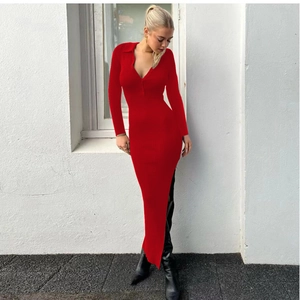 Close-up of ribbed knit fabric detail and side slit on this red polo neck maxi dress