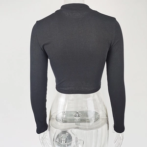 Rear view of a slim-fit black cropped long sleeve top with ribbed stretch fabric detail