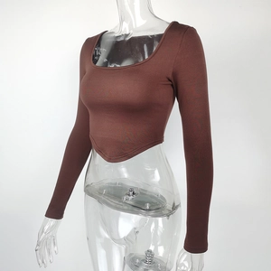Detailed side view of chocolate brown cropped long sleeve top with unique V-shape hemline