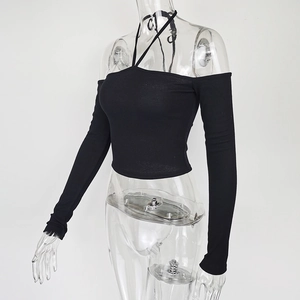 Detail of black ribbed long sleeve crop top with halter neck and off-shoulder design