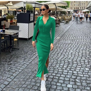 Detail of slim fit bright green ribbed knit dress with Polo neck and side slit design