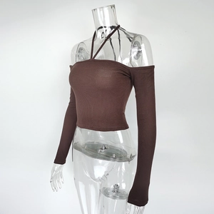 Detail of dark brown ribbed knit top with halter neck and off-the-shoulder design