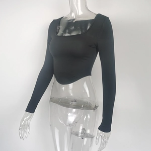 Close-up of black long sleeve crop top featuring square neckline and curved hem design