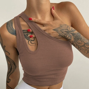 Close-up of brown ribbed knit crop top featuring a one-shoulder cutout detail on a model