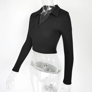 Detail of black ribbed knit long sleeve polo crop top with V-neckline and collar