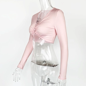 Détail d'un crop top rose à manches longues avec décolleté en V et fronces