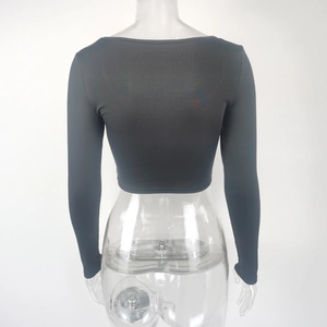 Detail view of the black long sleeve crop top showing the slim fit elastic knit fabric
