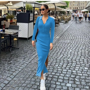 Detailed close-up of sky blue ribbed knit dress with polo neck and side slit detail
