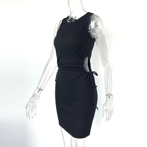 Detail of ribbed knit black dress featuring a side cutout and adjustable drawstring ties
