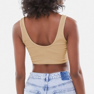 Back view of a khaki ribbed crop camisole paired with light blue washed denim jeans