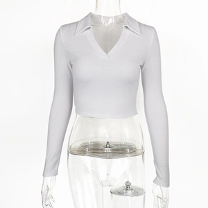 Detail of white ribbed knit long sleeve polo shirt with deep V-neck and cropped fit