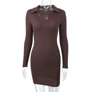 Detailed macro view of chocolate brown ribbed fabric on a tight polo collar mini dress