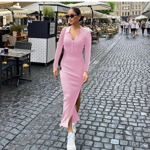 Detail of pink ribbed polo dress featuring a sleek buttoned collar and side slit hemline