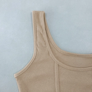 Detail of beige ribbed knit tank top showing high-quality texture and stitching