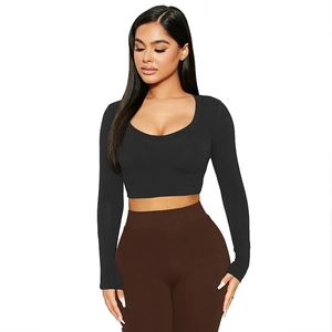 Close-up of a black long-sleeved crop top with a stylish U-neckline and slim fit