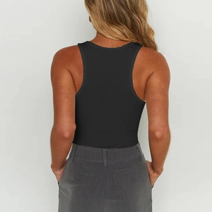 Back view of a sleek black racerback bodysuit paired with gray tailored trousers