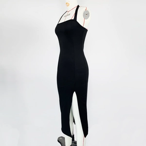 Detail of elegant black halter neck midi dress featuring a side slit and open back design