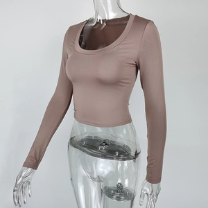 Detailed side view of slim fit U-neck long sleeve crop top in taupe on a model