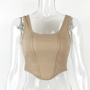 Detailed texture of ribbed knit fabric and curved hemline on a slim-fit crop top