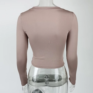 Rear view of tight-fitting dusty pink long sleeve cropped top on mannequin
