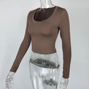 Detail of a brown long sleeve crop top featuring a deep U-neckline and slim fit knit fabric