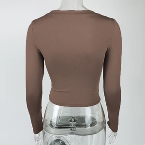 Detail view of the seamless back design on this dark brown fitted long sleeve crop top