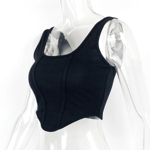 Side view of black ribbed corset top featuring boning seams and an asymmetric curved hem