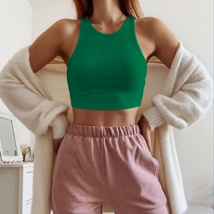 Detail of green ribbed crop top fabric and slim fit design on female model