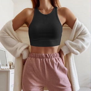 Detail of black ribbed crop top showing elastic cotton texture and slim fit design