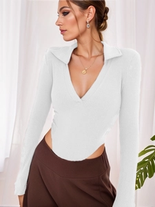 Close-up of white ribbed bodysuit showing polo collar and V-neckline texture