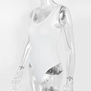 Detail view of white ribbed cotton bodysuit fabric showing vertical texture and stitching