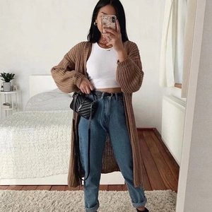 Detail of coffee brown long-knit cardigan showing chunky knit texture and loose fit style